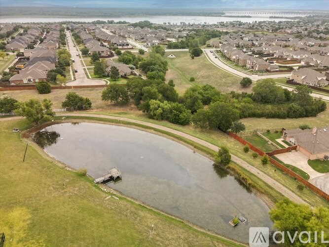A bird's eye view of a residential area with a lake in the foreground.