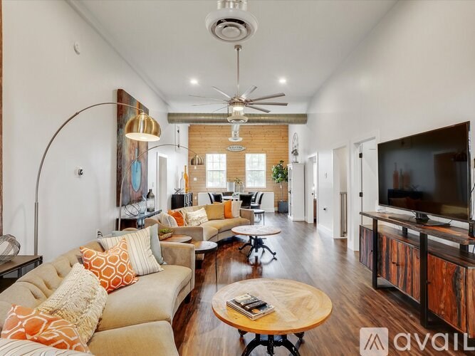 A living room with a large couch and a television.