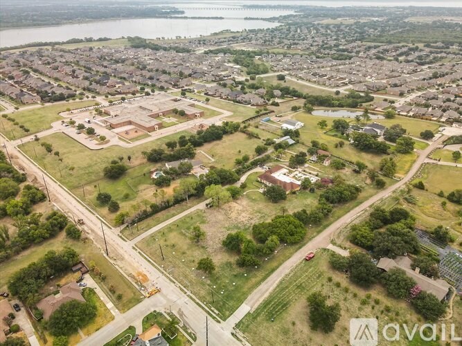 An aerial view of a residential area with a large body of water in the background.