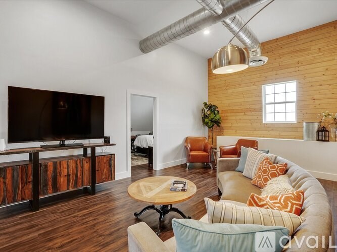 A living room with a television and a couch.