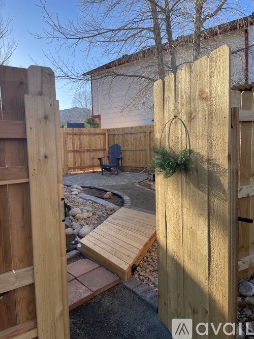 A wooden fence with a small garden in the middle.