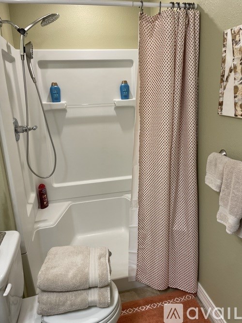 A white toilet with a towel on top of it in a bathroom.