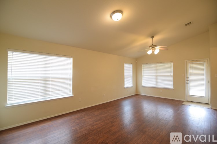 A room with wooden floors and a ceiling fan.