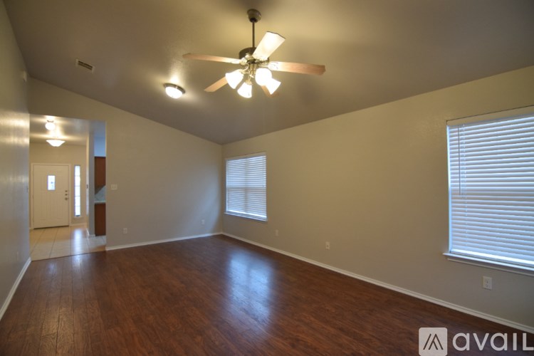 A bathroom with a tub, sink and mirror.