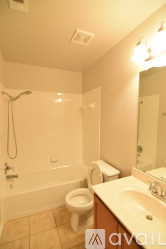 A room with a ceiling fan and carpeted floor.