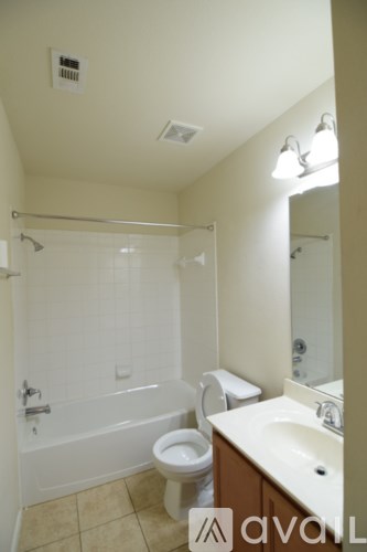 A bathroom with a toilet, sink, and bathtub.
