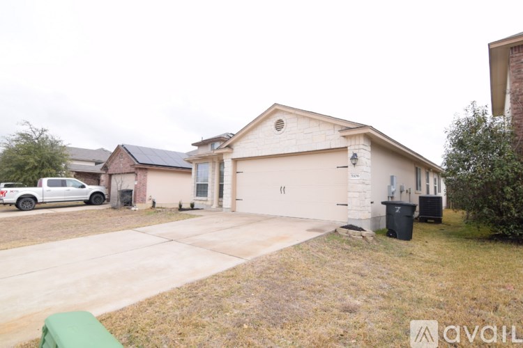 A house with a white pickup truck parked in front.