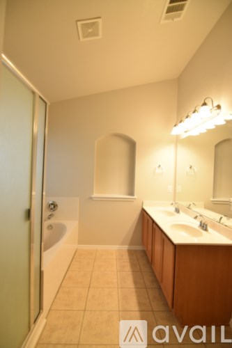 A kitchen with black appliances and brown cabinets.