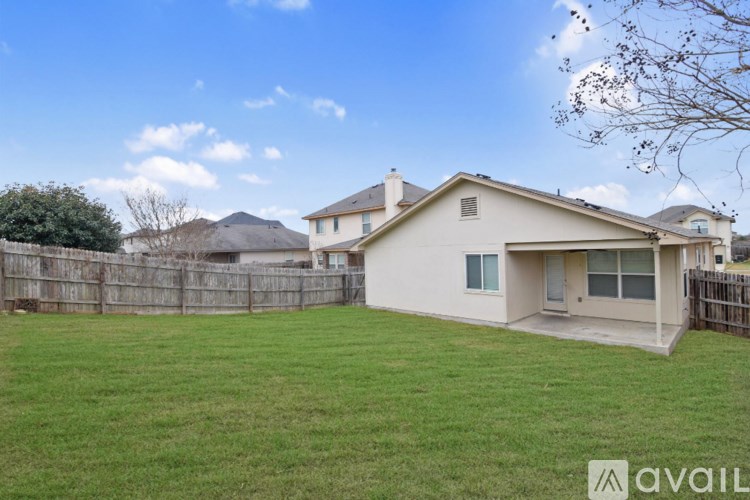 A chandelier hangs over a kitchen island with a microwave and oven.