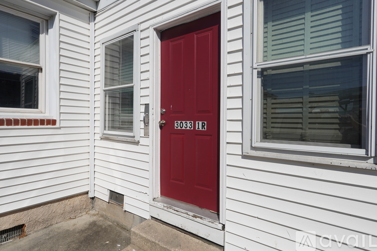 A red door with the number 3038 on it.