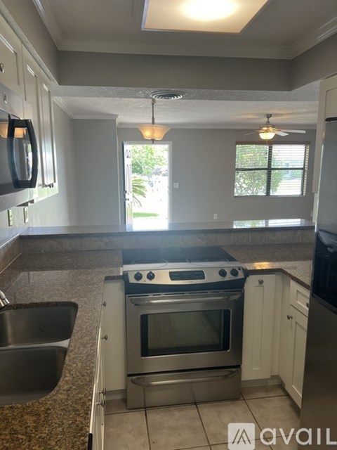 A kitchen with a stove top oven and a dishwasher.