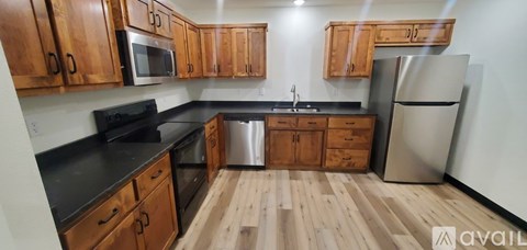 A kitchen with wooden cabinets and stainless steel appliances.