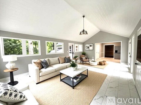A living room with a white couch and a coffee table.