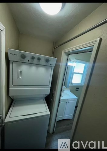 A small kitchen with a stove and a washing machine.