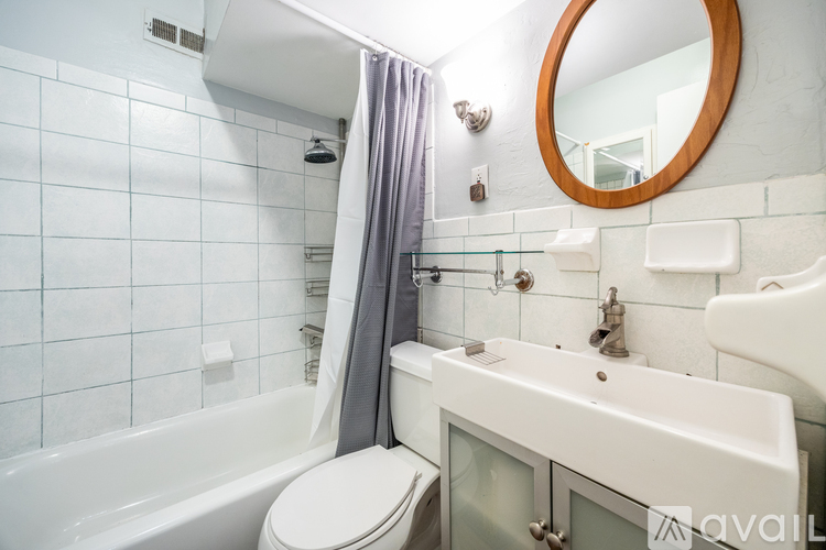 A bathroom with a white toilet, a white sink, and a white bathtub.