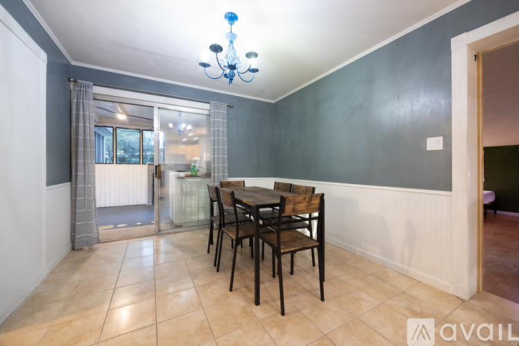 A dining room with a table set for four.