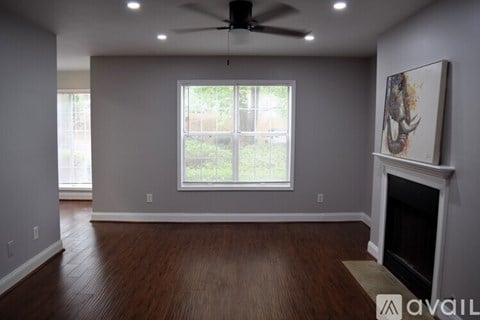 A living room with a fireplace and a painting on the wall.