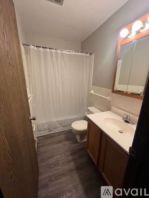 A bathroom with a toilet, sink, and shower.