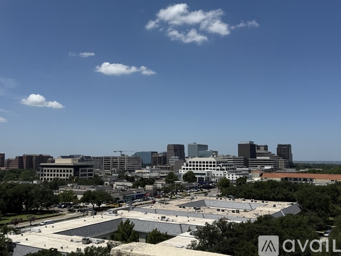 A cityscape with buildings and a clear sky.