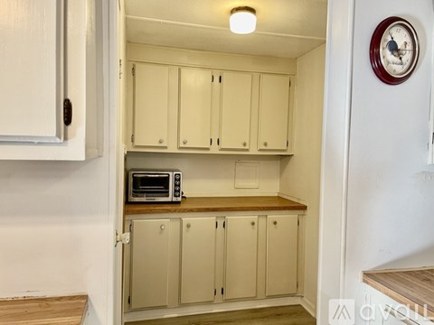 A kitchen with a microwave on the counter.