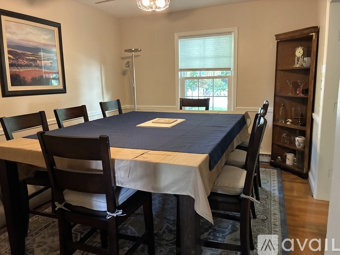 A dining room with a table and chairs.