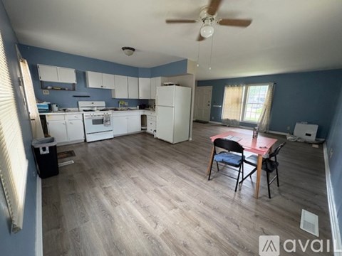 A kitchen with a table and chairs in the middle of the room.