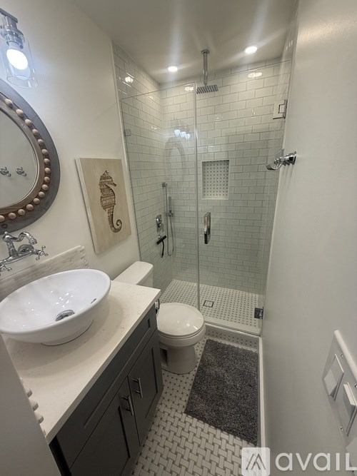 A bathroom with a white sink and a toilet.