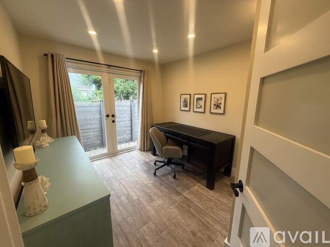 A room with a desk and a chair in it.