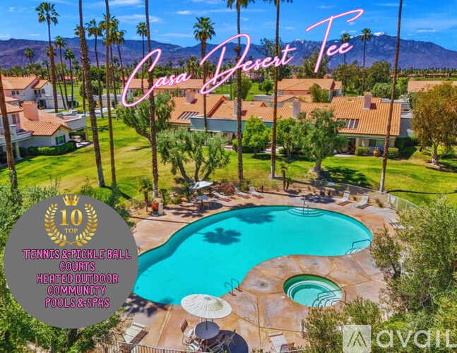 A pool surrounded by palm trees and a sign that says Casa Desert Tee.