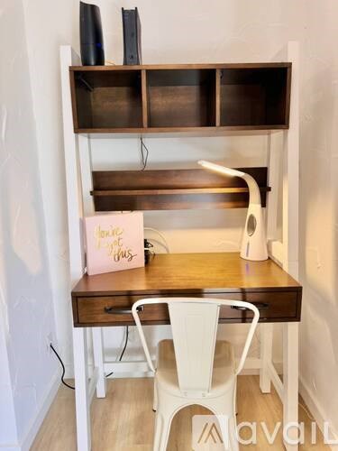 A desk with a white chair and a sign that says "you are my sunshine".