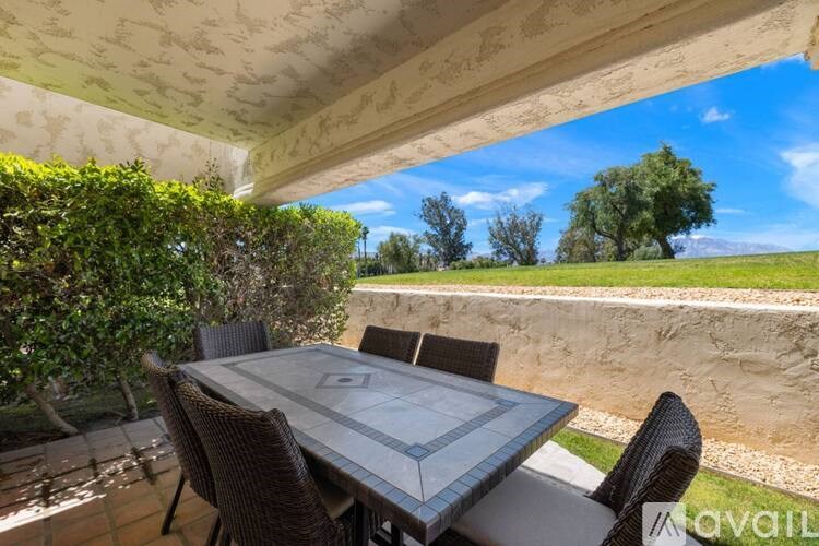 A table with chairs is set up on a patio.