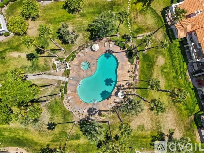 An aerial view of a backyard with a swimming pool and a patio area.