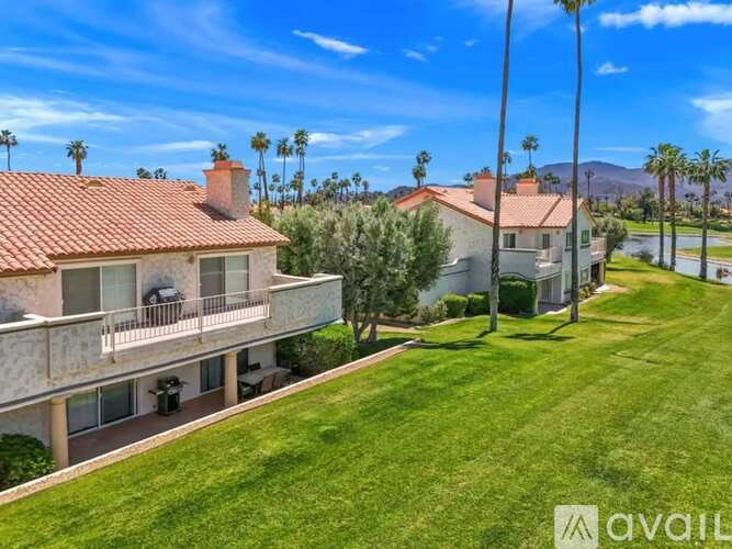 A house with a red tile roof is for sale.