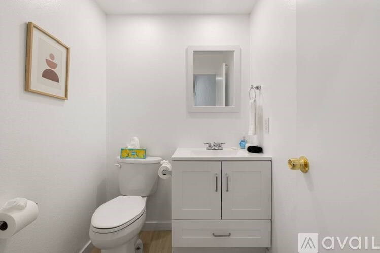 A white toilet and sink in a small bathroom.