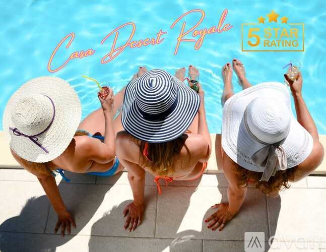 Three women wearing hats are sitting by a pool.