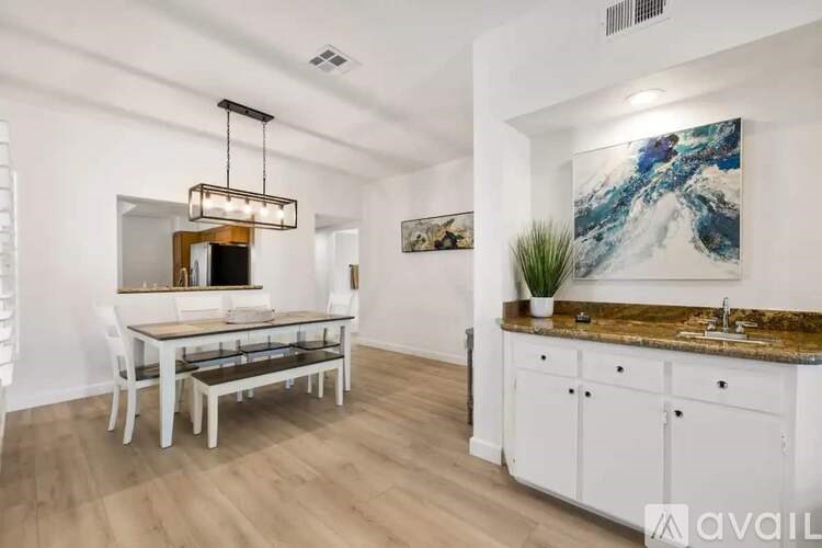 A modern kitchen with a dining table and chairs.