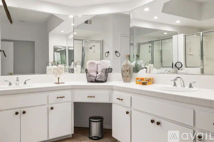 A bathroom with two sinks and a large mirror.