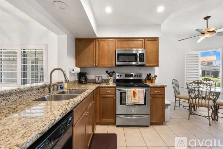 A kitchen with granite countertops and stainless steel appliances.
