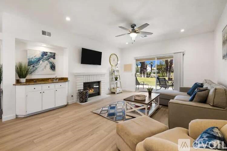 A living room with a fireplace, a couch, and a television.