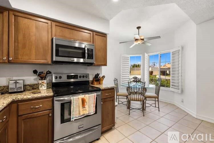 A kitchen with wooden cabinets and a stainless steel oven.