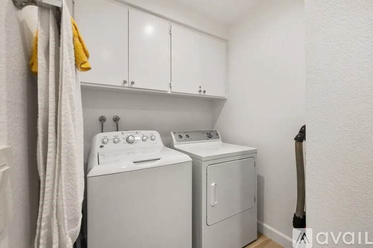 A small laundry room with a washer and dryer.