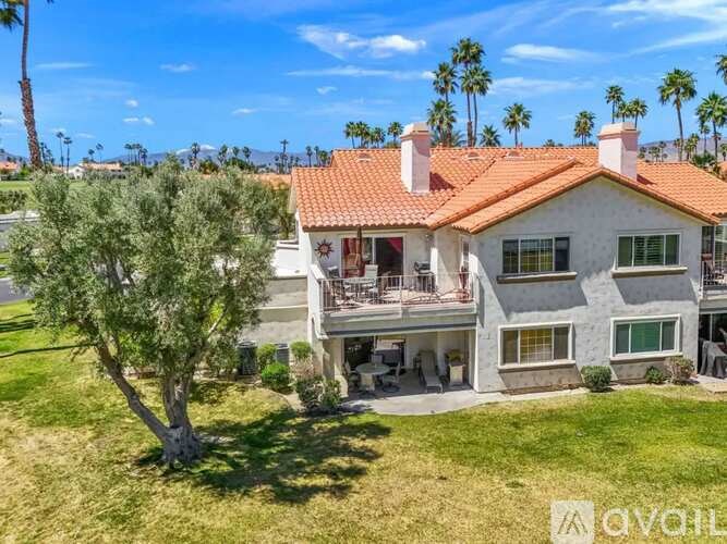 A house with a red tile roof and a balcony.