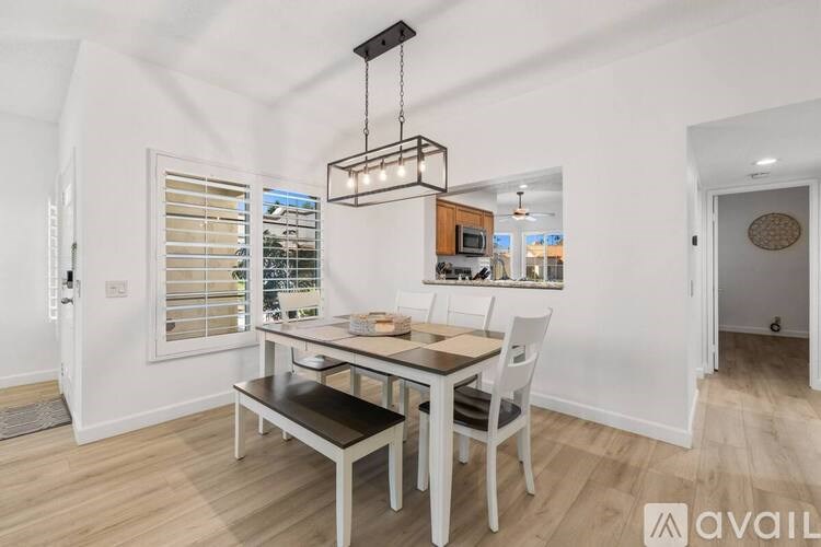 A dining area with a table and chairs is shown in the image.