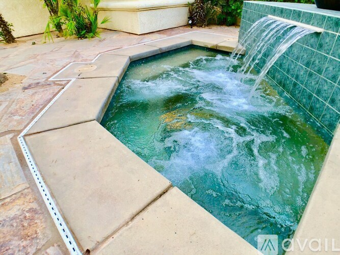 A small pool with a waterfall feature in the middle.