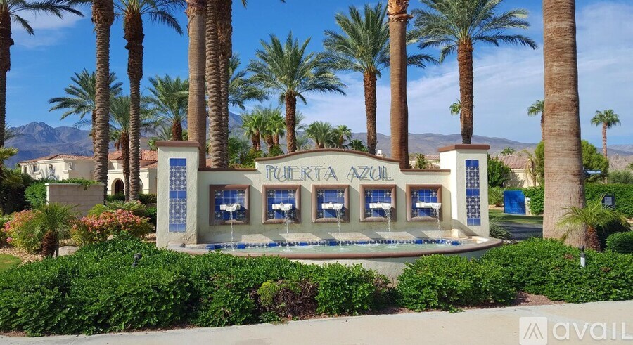 A sign for a place called "Tulum Azul" is surrounded by palm trees.