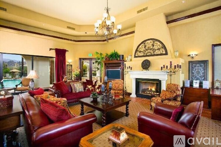 A living room with a fireplace and leather chairs.