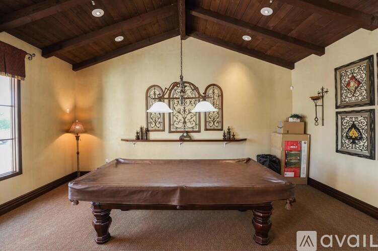 A bedroom with a large bed and a window.