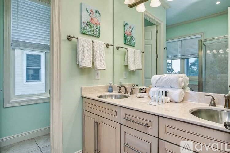 A bathroom with two sinks and a mirror.