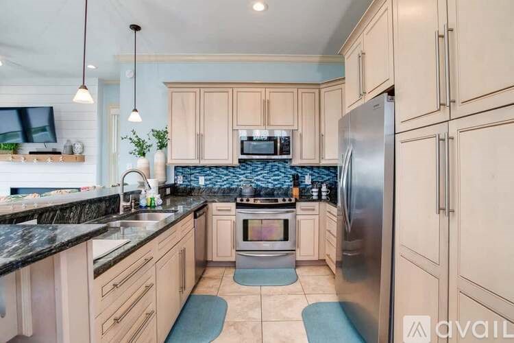 A kitchen with wooden cabinets and a black countertop.