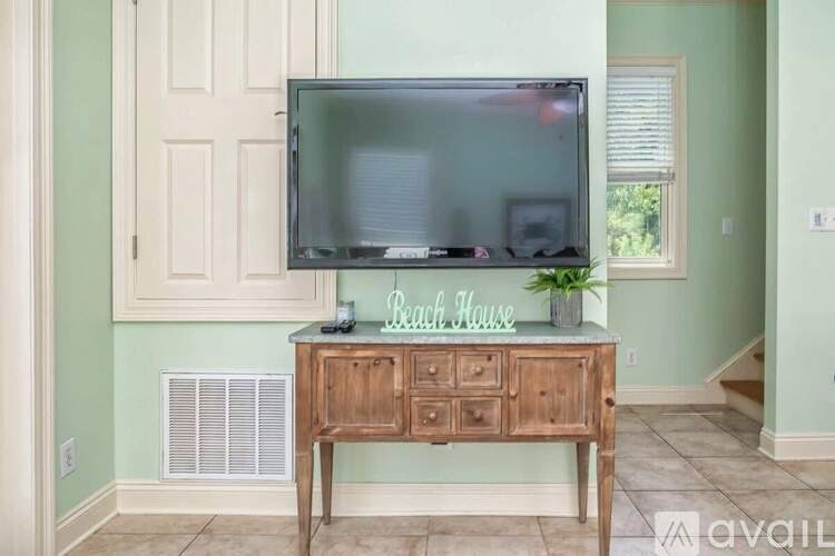 A television set on a wooden stand in a room.